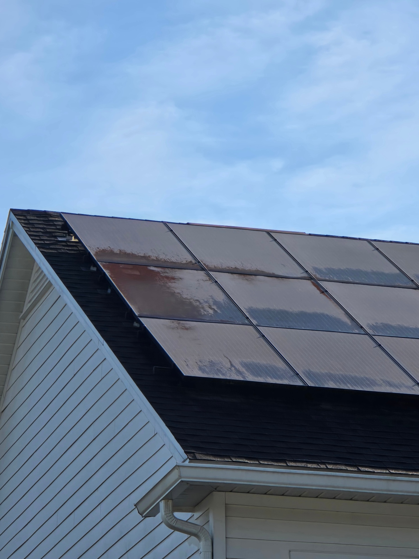 Rooftop solar panels covered in dirt, stains, and buildup blocking sunlight.
